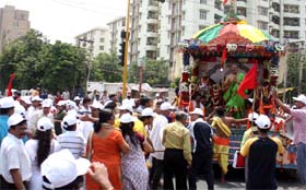 Devotees participate in the Jagannath Yatra at Gurgaon on Sunday