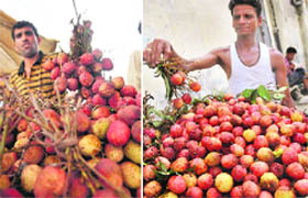 A fruit vendor sells litchis that have been artificially coloured; and (right) a seller with the fruit that has not been coloured in Ludhiana on Sunday.