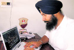 MC councillor Tanvir Singh Dhaliwal browses through his website in Ludhiana on Sunday.