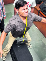 Rakesh Kumar lifts a 10-kg weight with his left eye in Ludhiana on Sunday. 