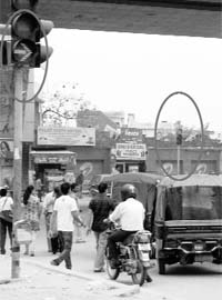 While the traffic lights near the zebra crossing show green light, the one across the road still has a stop sign at Zirakpur