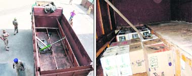 Novel way A modified truck seized by the police; and (right) cartons lying in the false chamber of the truck