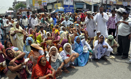 Old age pensioners stage a dharna at Air Force Road in Faridabad on Monday.