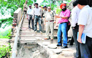 Officials inspect the damaged route to the Mata Mansa Devi shrine in Haridwar 