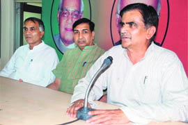 Om Prakash Dhankar, president of the BJP Kisan Morcha, addresses a press conference in Dehradun 