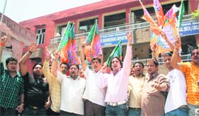Activists of the Bharatiya Janata Yuva Morcha stage a protest against water shortage in Jammu on Monday