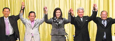  Pheu Thai Partys Yingluck Shinawatra (centre) poses for a photo with her coalition partners after a joint news conference in Bangkok