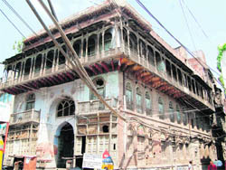 Coils of power supply cables cover the facade of a heritage building near the Golden Temple. The building has been serving as a sarai for pilgrims for over a century and a half.