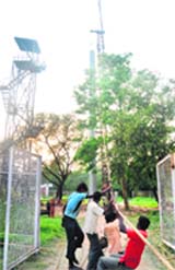 Workers raise a pole to install floodlights at the cricket stadium in Sector 16, Chandigarh.