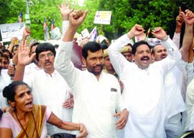 President of the Lok Janshakti Party Ram Vilas Paswan with party activists shouts slogans during a demonstration against the Bihar government for their various demands at Jantar Mantar in New Delhi on Tuesday
