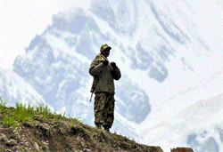 A securityman keeps vigil near the Panjtarni base camp en route Amarnath shrine