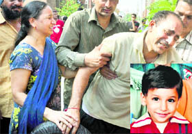 Neighbours console Amans (inset) parents outside their house in Jalandhar on Tuesday. 