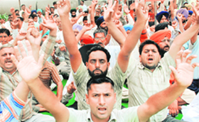 Members of the Field and Workshop Workers Union (Punjab) stage a protest to press for their demands at Industrial Area in Phase 7 of Mohali on Wednesday.