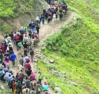 Track of Faith: Pilgrims traverse difficult terrain at Sangam on the way to the Amarnath cave shrine on Wednesday. 
