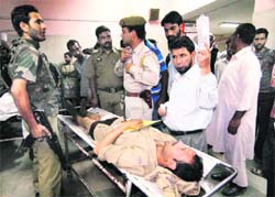 A policeman injured in a blast in Sopore being admitted to hospital in Srinagar on Wednesday.