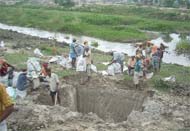 Labourers digging out silt from the bed of the Gang canal to make it fit to carry water again.
