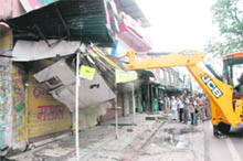 A JCB vehicle in action during an anti-encroachment drive at Hathibarkala on Thursday