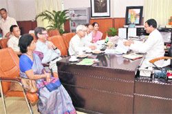 Chief Minister Ramesh Pokhriyal Nishank interacts with members of the Uttarakhand Public Service Commission in Dehradun on Thursday.
