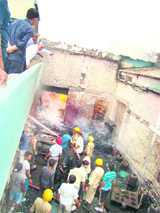 Firefighters try to douse the flames in an industrial unit at Baddi on Thursday.