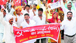 Activists of the CPM hold a protest against former sarpanch Karam Singhs murder and the price rise, in Karnal on Thursday.