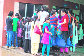 Girls wait for their turn to submit admission forms at Government College for Women at Gandhi Nagar in Jammu on Thursday.