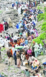 Covering themselves, pilgrims continue the yatra on the Pahalgam route to the Amarnath cave shrine on Thursday.