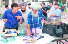Food inspector Manoj Khosla (left) along with District Health Officer Dr Kulwinder Singh (in the middle) collecting food samples at Malhotra Palace 