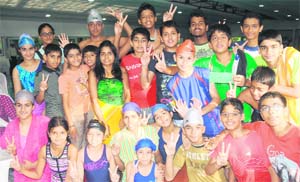 Winners strike a pose at the Sector 23 swimming pool in Chandigarh on Friday.