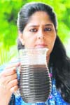 Shweta, a resident of Sector 21, shows muddy tap water in Chandigarh on Friday.
