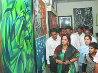 Former actor and Samajwadi Party leader Jayaprada admires a painting at the exhibition in New Delhi on Friday.