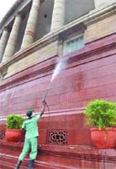 A worker cleans the Parliament in New Delhi on Friday. 