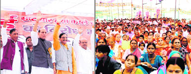 Former Uttar Pradesh Chief Minister Rajnath Singh, Uttarakhand Chief Minister Ramesh Pokhriyal Nishank and other party leaders wave to the crowd at a rally in Haridwar on Friday; and  (right) supporters at the rally. 