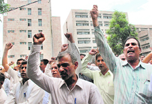 Protesting teachers raise slogans outside the office of the Director-General, Higher Education, at Panchkula on Friday