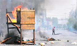 Protesters burn material in a violence-hit western neighbourhood of Karachi 