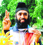 Manpreet shows his medal.
