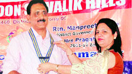 Surendra Petwal, new president of the Rotary Doon Shivalik Hills Club, is felicitated by the former president in Dehradun on Saturday.