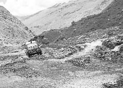 The melted water flows on the highway in Lahaul. 
