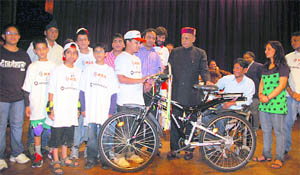 Chief Minister PK Dhumal distributes prizes among children during an awareness programme at the Gaiety Theatre in Shimla 