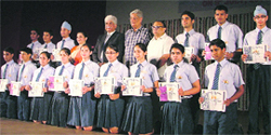 meritorious students display their awards during the prize distribution function in Ludhiana on Saturday