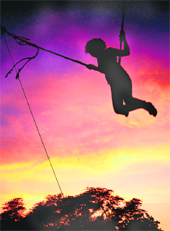 A child enjoys hoimself on a swing on a pleaseant evening in Chandigarh on Sunday.