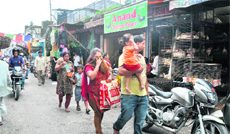 People walk past Machi Bazar on a road that leads to Ward No. 18. People walk past Machi Bazar on a road that leads to Ward No. 18. A Tribune photograph 