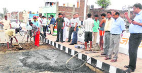 The damaged portion of the railway overbridge being repaired at Kaithal on Sunday. This portion developed cracks the very next day of the opening of the overbridge by the Chief Minister on Friday.