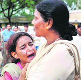 A girl breaks down after seeing her mothers body.