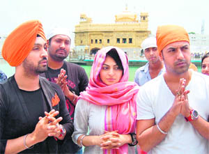 Bollywood actress Neeru Bajwa and Punjabi actors Diljit Dosanjh and Gippy Grewal pay obeisance at the Golden Temple in Amritsar on Sunday. They visited the city for the promotion of their upcoming Punjabi film Jinhe Mera Dil Luteya.