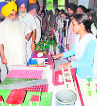 Punjab Education Minister Sewa Singh Sekhwan looks at a model during a science exhibition at State College for Education in Patiala on Sunday