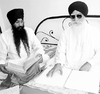 Bhai Gurmej Singh and his nephew Jagjit Singh doing proof reading work at his residence in Amritsar on Sunday