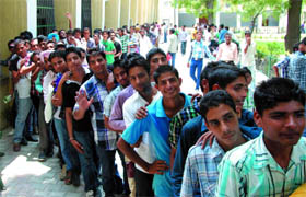 Students await their turn to deposit admission fee at the Government Rajindera College in Bathinda on Monday.