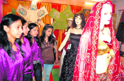 Students have a look at dresses at an exhibition in Haridwar on Monday.