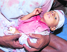A child, who was injured after his school bus overturned, in a hospital in Sirsa 