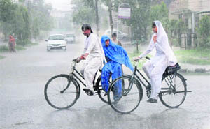 Schoolgirls caught unaware on their way back home as sudden showers lash Karnal. 